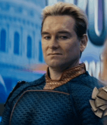 a close up of a man 's face wearing a blue jacket with a brown collar .