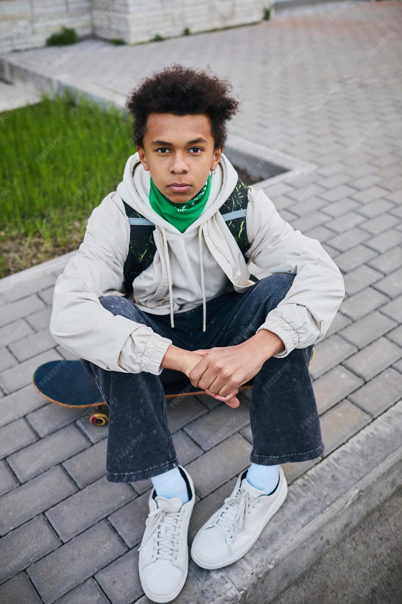 portrait-african-teenage-boy-sitting-his-skateboard-looking-camera-spending-time-outdoors_236854-40849.jpg