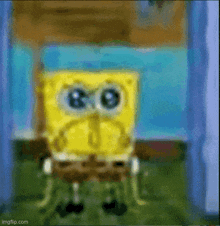 a blurry picture of spongebob squarepants standing in front of a blue wall .