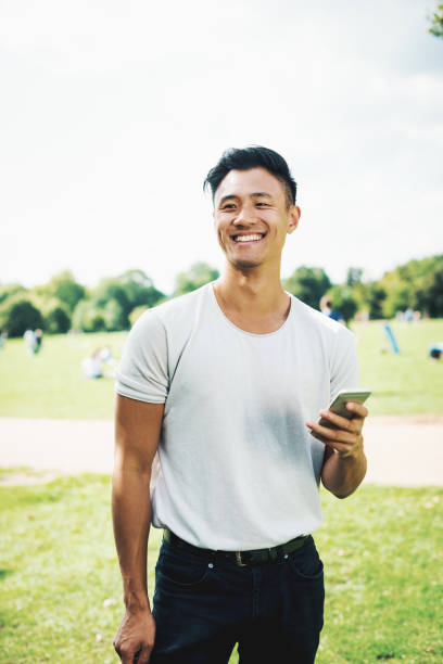 handsome-chinese-guy-with-smartphone-in-park.jpg