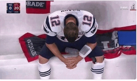 a football player with the number 12 on his jersey kneeling down