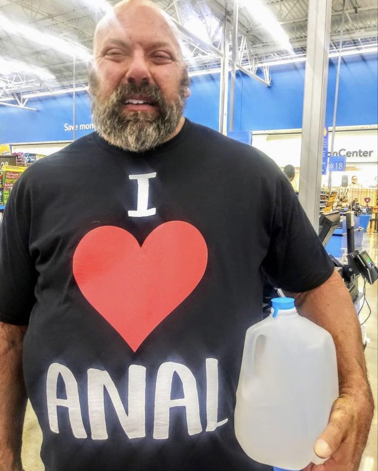 This may contain: a man in a black shirt with an i heart anai t - shirt on