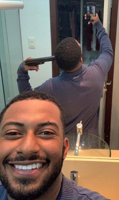 reactions on X: man smiling taking selfie but mirror in background shows  he is pointing a gun at his own head https://t.co/QP21jQjXWL / X