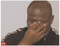 a man covering his face with his hand with a ws logo in the corner