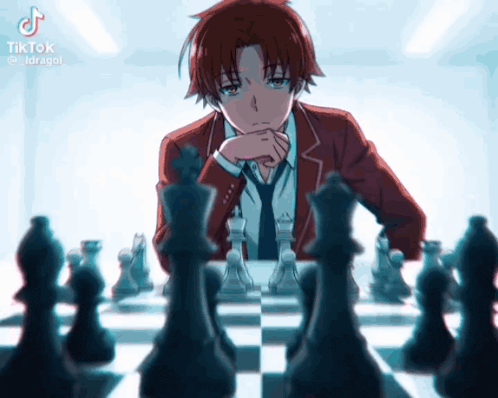 a man in a suit and tie is playing a game of chess .