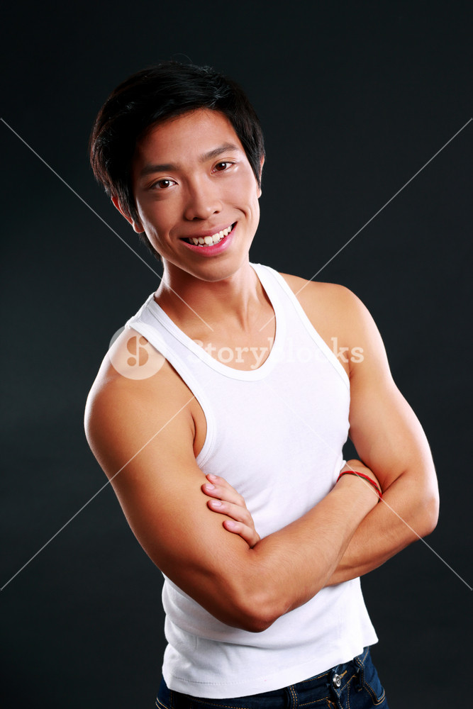 portrait-of-a-smiling-asian-man-with-arms-folded-on-black-background_HYcZqkdAri_SB_PM.jpg