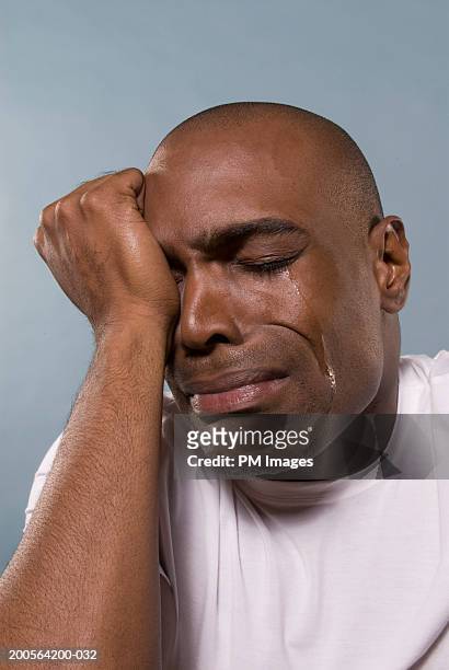 man-with-head-in-hands-crying-close-up.jpg