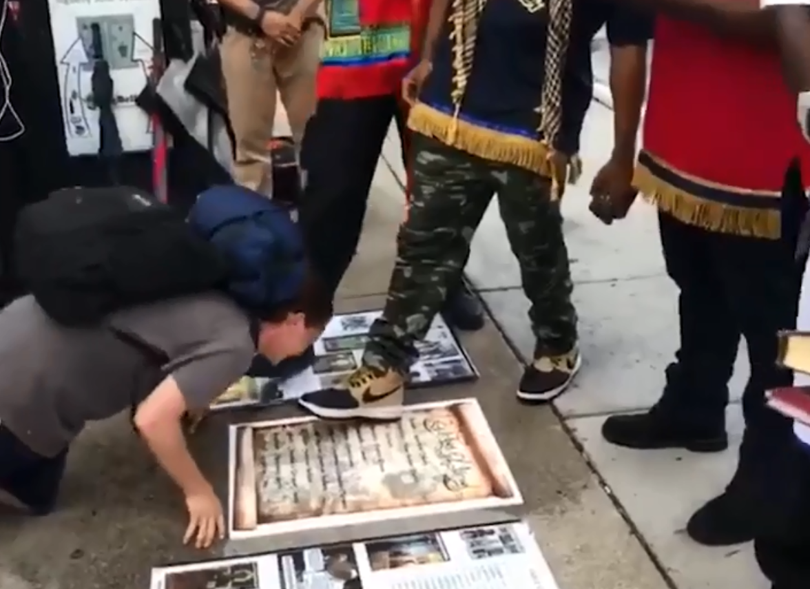 Black supremacists film white people kissing their boots to apologise for  centuries of racism in bizarre stunt