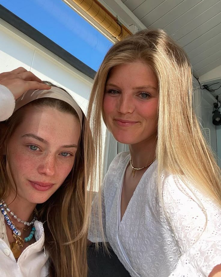 This may contain: two beautiful young women standing next to each other