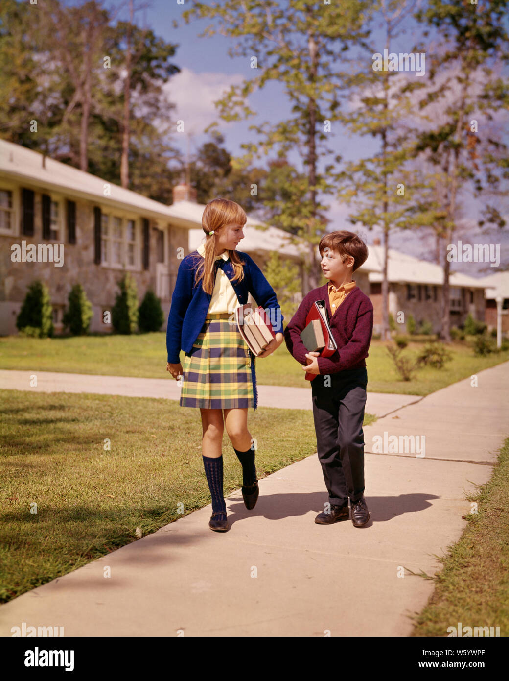 1960s-boy-and-girl-brother-sister-walking-down-suburban-street-carrying-school-books-talking-wearing-sweaters-girl-wearing-kilt-ks5404-har001-hars-sister-1-juvenile-style-communication-joy-lifestyle-architecture-brick-females-houses-brothers-home-life-copy-space-friendship-full-length-residential-males-buildings-siblings-sisters-property-styles-and-hairstyle-knowledge-homes-plaid-skirt-sibling-sweaters-real-estate-connection-knee-socks-structures-wears-residence-stylish-edifice-short-skirt-cooperation-fashions-juveniles-pre-teen-pre-teen-girl-togetherness-bangs-caucasian-ethnicity-har001-W5YWPF.jpg