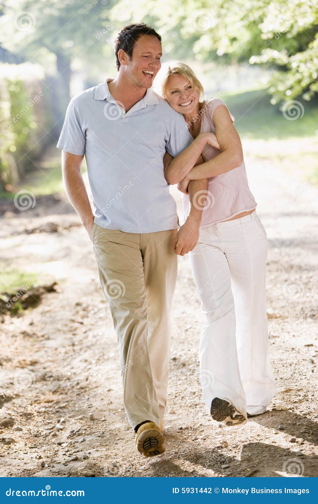 couple-walking-outdoors-arm-arm-smiling-5931442.jpg