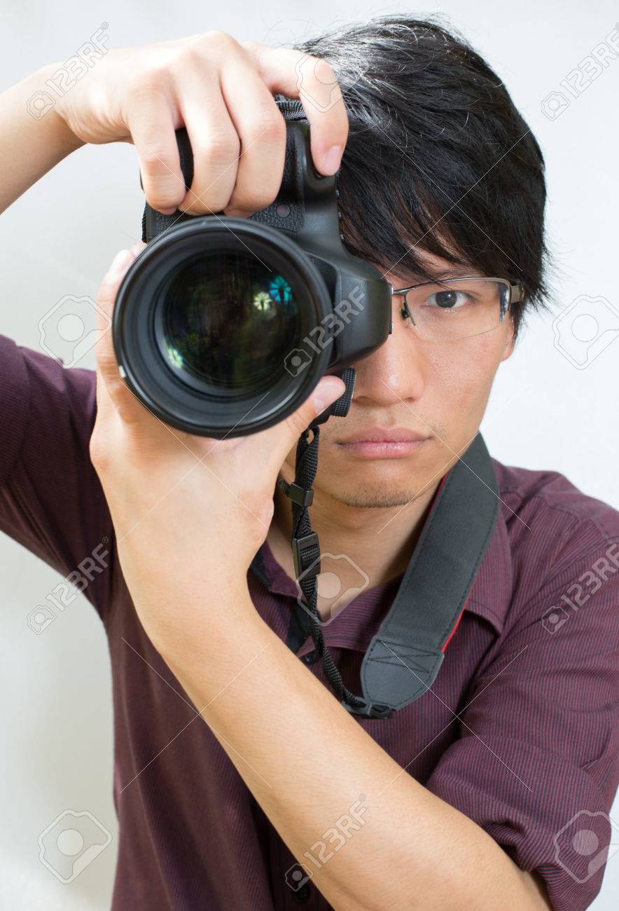 31023992-asian-man-taking-a-picture-with-dslr-camera.jpg