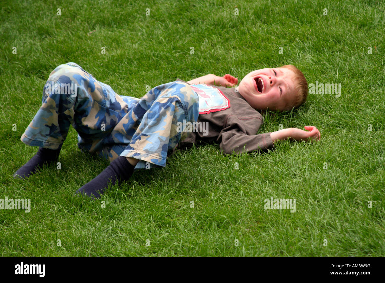 6-year-old-boy-laying-on-ground-crying-AM3W9G.jpg