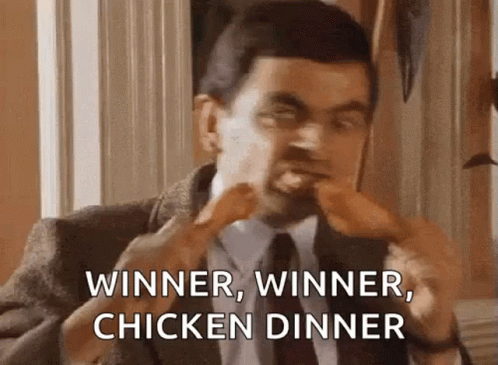 mr bean is eating chicken wings and saying `` winner , winner , chicken dinner ''