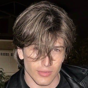 This may contain: a close up of a person wearing a leather jacket
