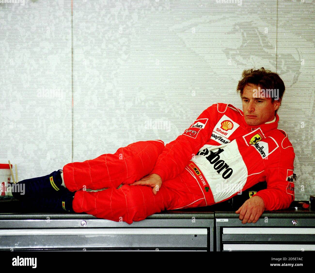 irish-driver-eddie-irvine-rests-in-his-teams-pit-during-a-break-in-testing-at-the-jerez-racetrack-january-13-several-teams-are-testing-their-new-cars-ahead-of-the-start-of-the-1998-formula-one-season-sport-motor-racing-2D5E7AC.jpg