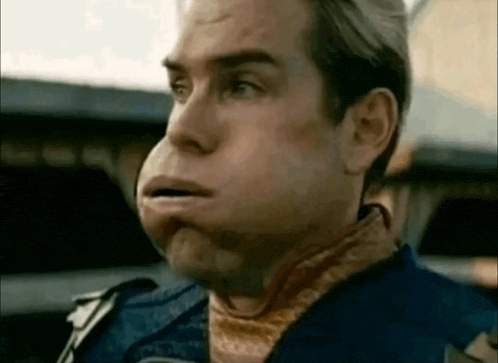 a close up of a man 's face with his mouth open and a scarf around his neck .