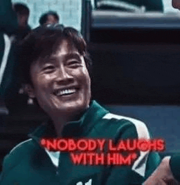 a man in a green jacket is smiling and laughing with another man .
