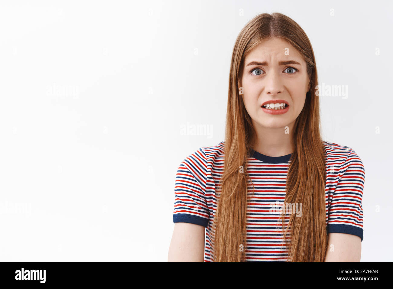 girl-feeling-scared-of-consequences-look-embarrassed-and-nervous-cringe-face-and-clench-teeth-frowning-bothered-standing-concerned-and-anxious-2A7FEAB.jpg