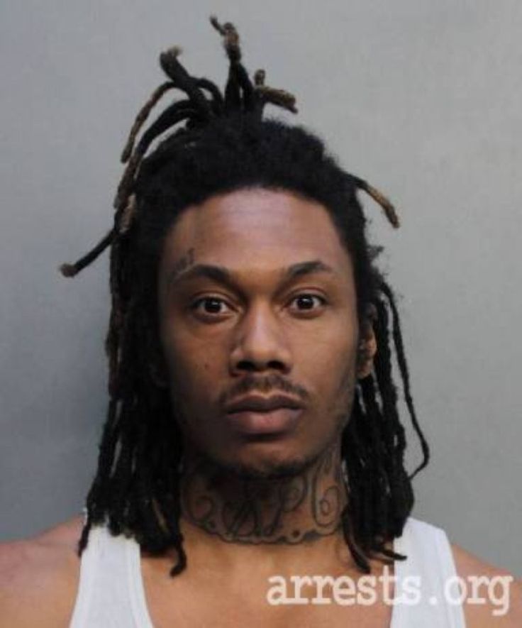 This may contain: a man with dreadlocks is shown in this mug shot