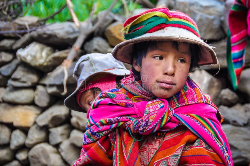 quechua-boy-sister-village-andes-ollantaytambo-mountains-over-peru-62856170.jpg