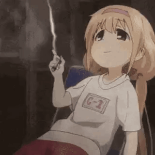 a girl is sitting in a chair holding a lighter and smiling .
