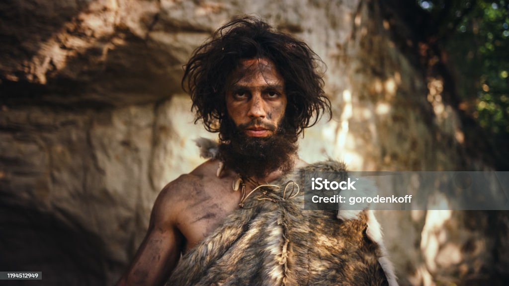 portrait-of-primeval-caveman-wearing-animal-skin-holding-stone-tipped-hammer-prehistoric.jpg
