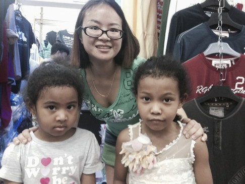 A trader with her Afro-Chinese daughters at the Tang Qi Arcade, in Guangyuan Xi Lu. Photo: Jenni Marsh