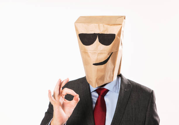 cool-businessman-in-suit-wearing-cartoon-paper-bag-looks-smug-as-he-makes-the-ok-sign-with.jpg