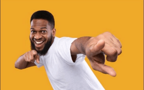 a man with a beard is pointing at the camera
