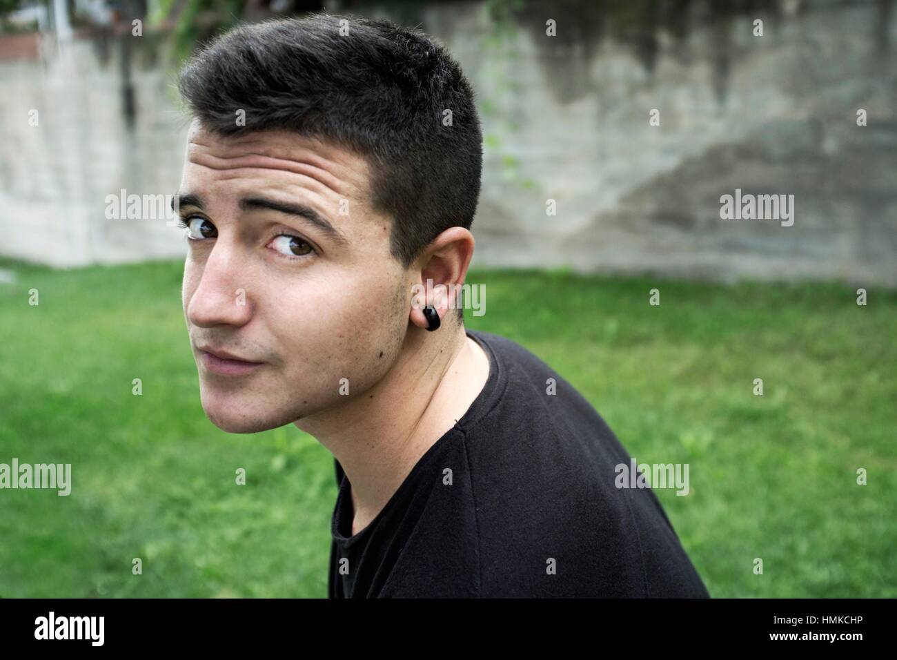 18-year-old-man-in-a-garden-barcelona-spain-europe-HMKCHP.jpg