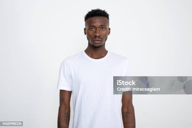 african-american-man-in-white-t-shirt-looking-at-camera-against-white-background.jpg