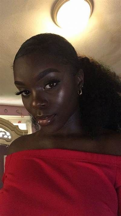 This may contain: a woman in a red off the shoulder top looking at the camera with an intense look on her face