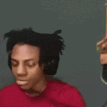 a close up of a person wearing headphones and a red shirt