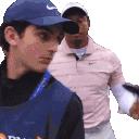 a man wearing a blue hat is standing next to another man