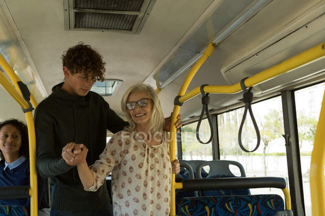 focused_207452472-stock-photo-young-man-helping-senior-woman.jpg