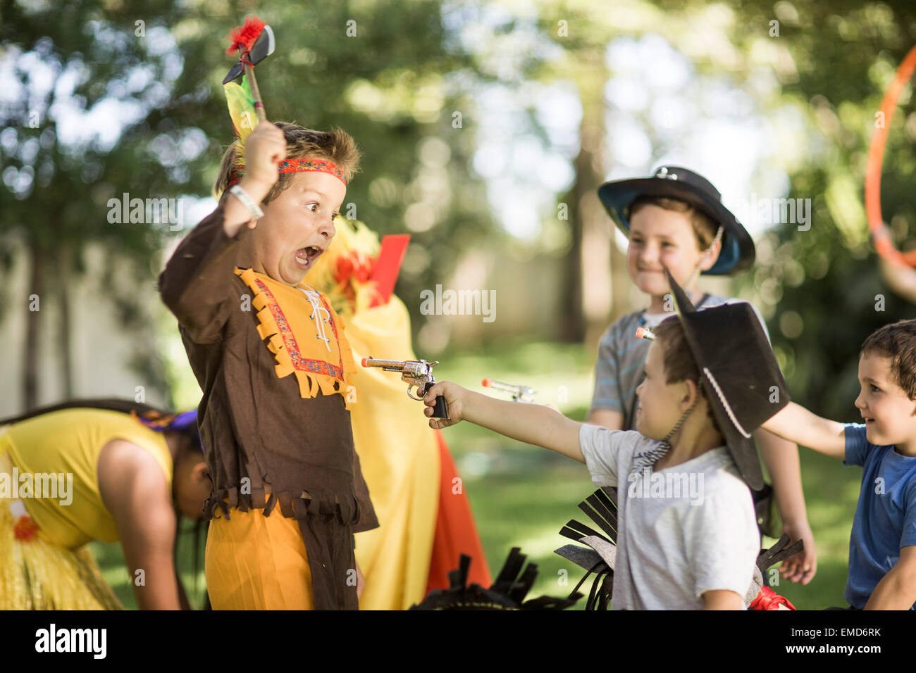 kids-in-garden-playing-cowboys-and-indians-EMD6RK.jpg