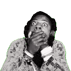 a man wearing headphones covering his mouth with his hands