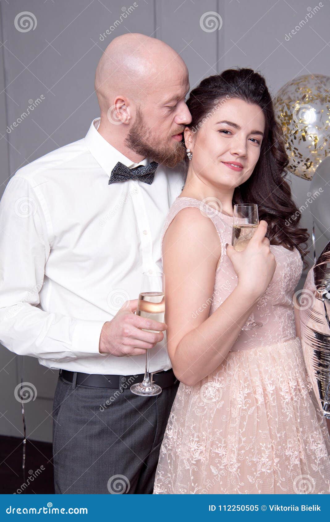 handsome-bald-man-beard-hugs-her-girlfriend-men-glass-champagne-112250505.jpg