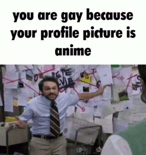 a man in a suit and tie is standing in front of a wall with papers on it and a bulletin board .