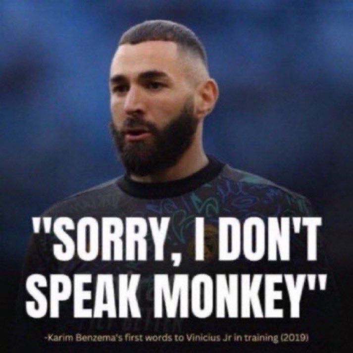 This may contain: a man with a beard standing in front of a sign that says sorry, i don't speak monkeyy