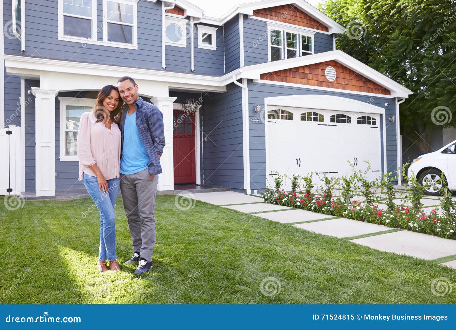 happy-black-couple-standing-outside-their-house-71524815.jpg