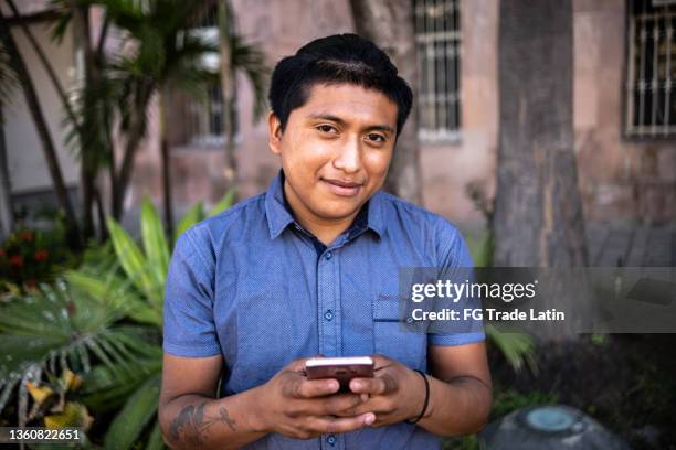 portrait-of-a-young-man-using-smartphone-outdoors.jpg