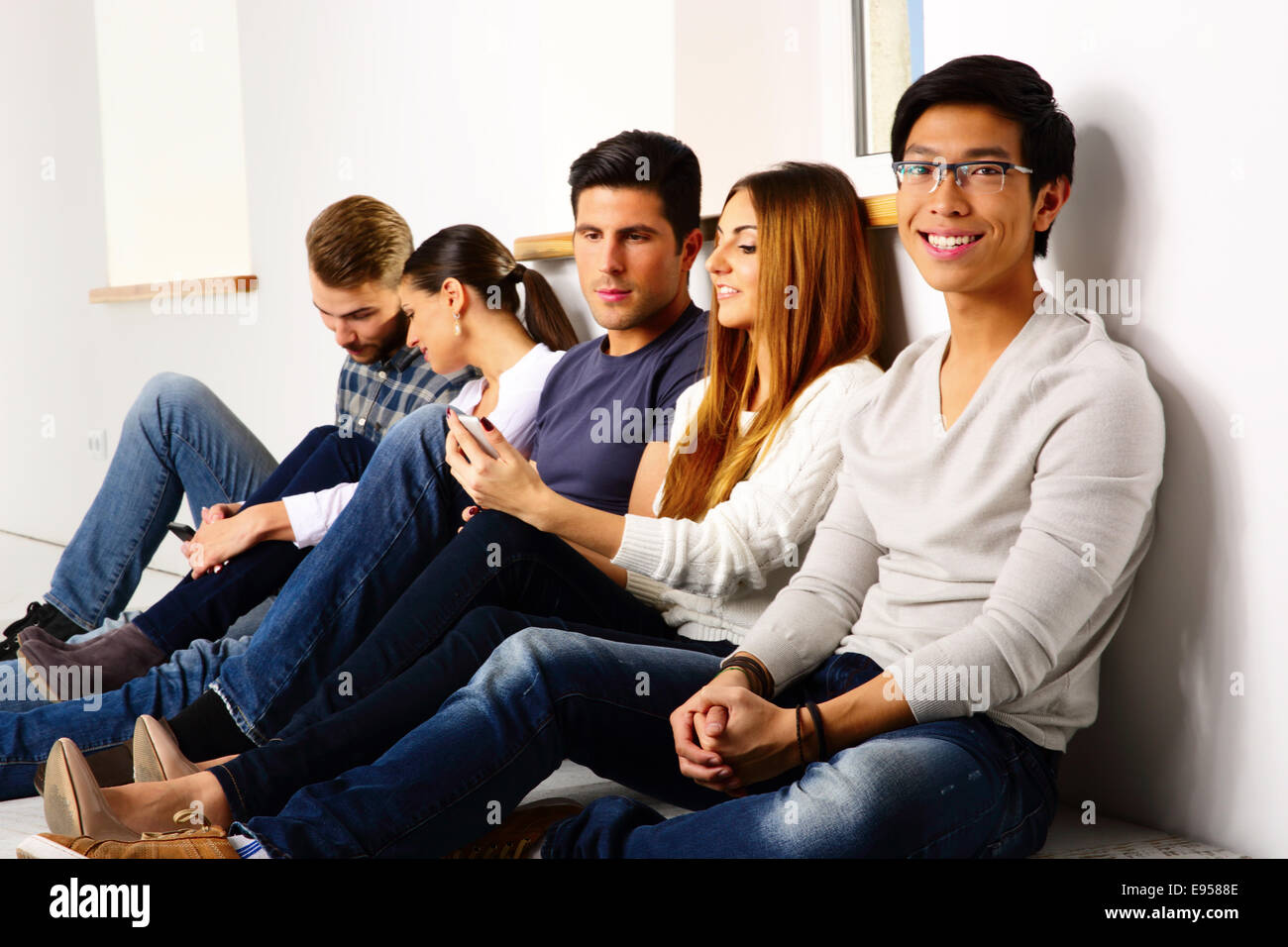 group-of-a-happy-friends-sitting-on-the-floor-E9588E.jpg