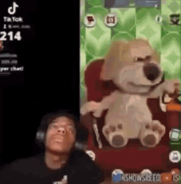 a man is sitting in front of a teddy bear .