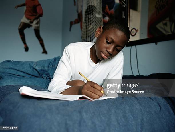 boy-doing-homework-on-bed.jpg