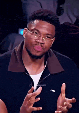 a man wearing glasses is making a funny face