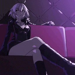 a girl is sitting on a purple couch