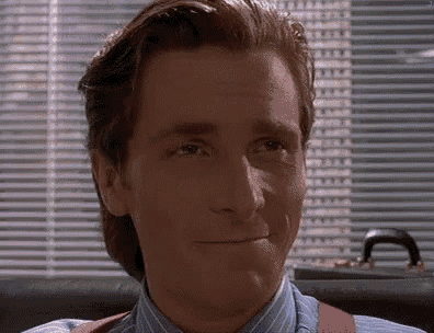 a close up of a man wearing suspenders and a blue shirt making a funny face .