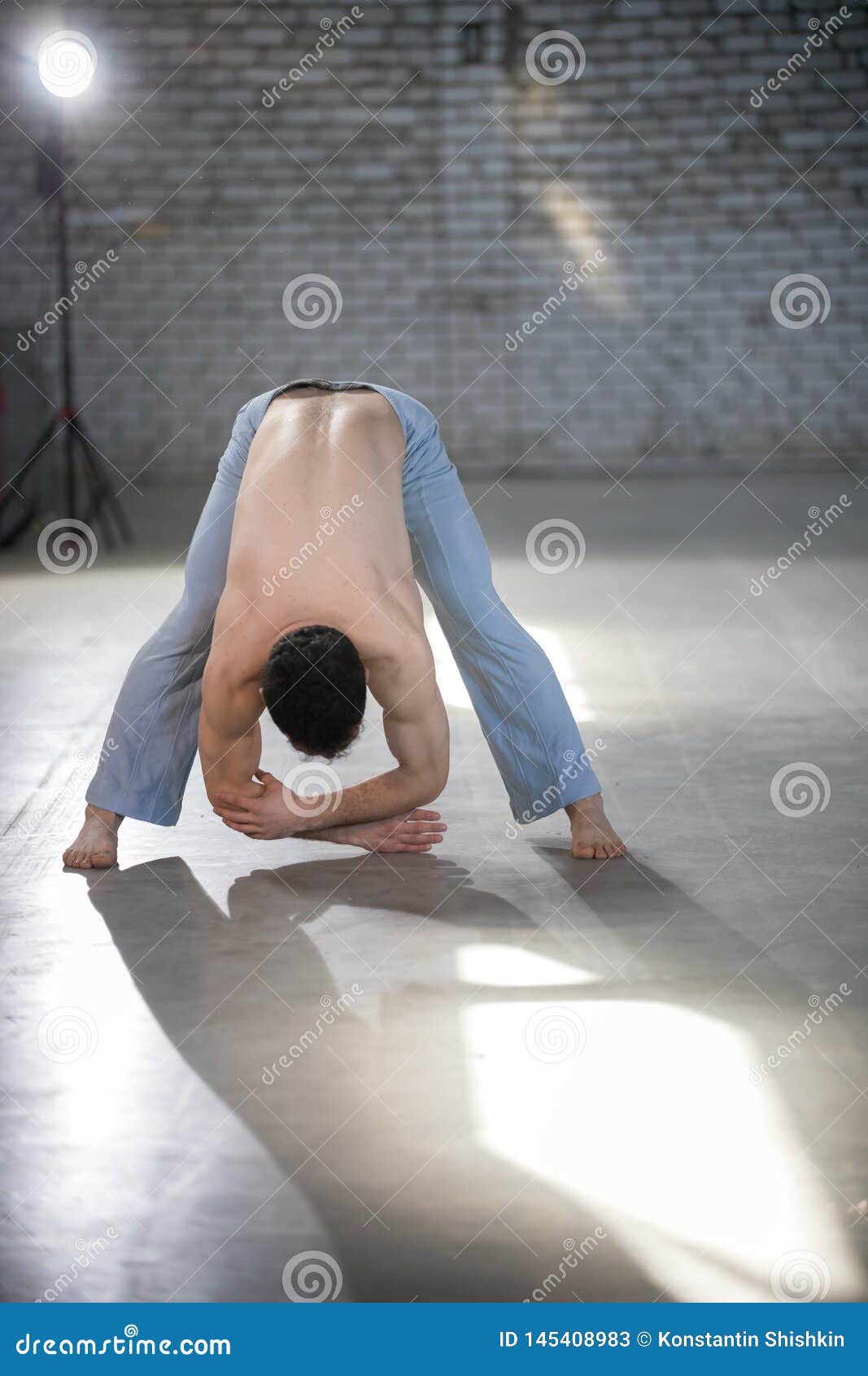 athletic-man-capoeira-training-bending-down-spine-stretching-athletic-man-capoeira-training-bending-down-spine-145408983.jpg